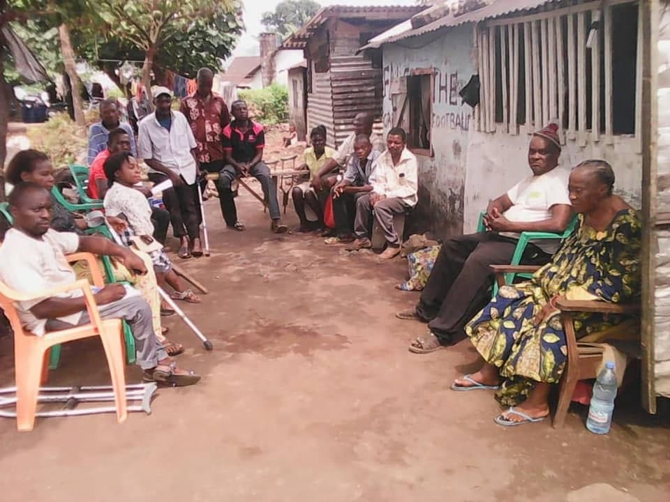 A Be Real Humanitarian Works team member listening to a family during a community visit